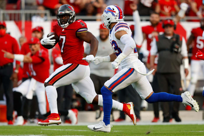 Tampa Bay Buccaneers running back Leonard Fournette (7) runs past Buffalo Bills safety Micah Hyde (23) in the first half at Raymond James Stadium.